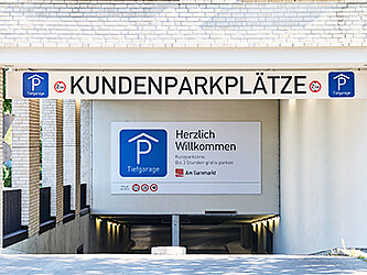 Foto von einem Tiefgarageneingang mit Aufschrift "Kundenparkplatz".